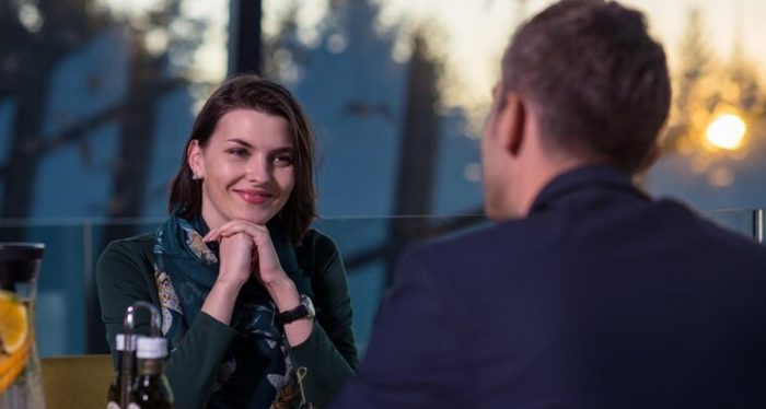 Two people talking across a restaurant table