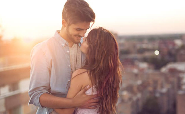 A couple embracing outdoors in evening light