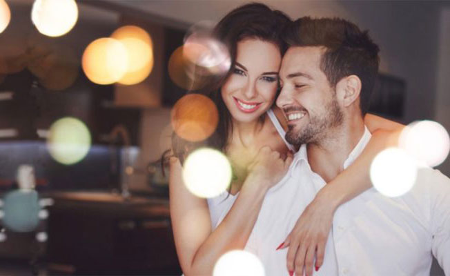 A couple smiling together in warm evening light